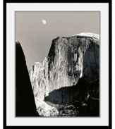 The force of Half Dome, contained in a black satin, deep profile frame. Famous for his black and white renderings of America's national parks, photographer Ansel Adams captures Yosemite's most well-known site under dramatic shadows.
