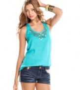 Tough studs and glimmering paillettes add embellished cool to a pretty tank top of tropical hue! From Eyeshadow.