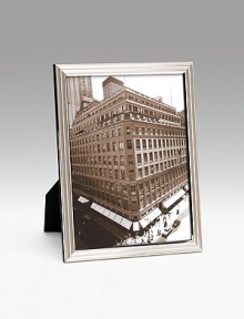Modern silverplate design holds a favorite photo vertically or horizontally. Polished cedar wood back Made in Italy Modern silverplate design holds a favorite photo vertically or horizontally. Polished cedar wood back Made in Italy
