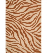 Survival of the prettiest. An exotic print adorns Nourison's Skyland rug in perfectly paired hues of ivory and rust, bringing a wildly chic look to any space. The plush wool rug is enhanced with meticulous hand carving for beautiful detail and texture.