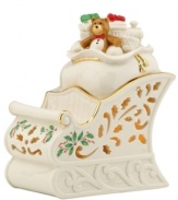With an inner glow, pierced detail and a holly motif to match the beloved Holiday pattern, this porcelain sleigh figurine from Lenox captures the childlike joy of the season.