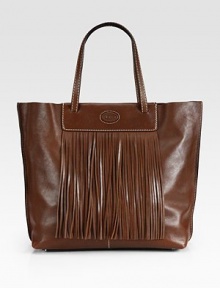 An easy shape of lustrous leather, topped off with fringe detailing for a boost of style. Double top handles, 7 dropSnap top closureOne inside open pocketFully lined16W X 12H X 5DMade in Italy