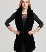 In plush faux fur, Black Halo's Braiden vest lends a cozy layer over a fitted sheath dress.