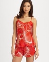 Delicate feathers float across this silky-smooth print, with pretty lace adorning the neckline and a seductive crossed back. Sweetheart neckline with lace trimAdjustable spaghetti straps with V backInseam, about 5PolyesterMachine washImported