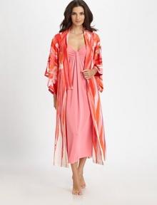 A floral watercolor print in vivid hues cascades down this silky-smooth layering piece. V-neckDropped shouldersThree-quarter length dolman sleevesSelf-tie waistAbout 49 from shoulder to hemPolyesterMachine washImported