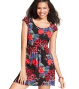 Backed by crisscrossed panels of lace, washed in a whimsical floral-print, Angie's cap sleeve dress makes pretty style yours.