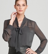 A sheer silhouette lends provocative edge to a classic DKNY blouse, flaunting a generous neck tie for an alluring feminine statement.