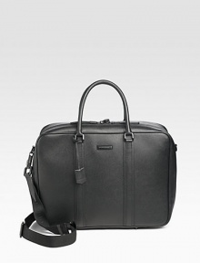 A sophisticated case crafted in granulated leather with iconic check lining and straps inside to hold all of your belongings in place. Zip closure with lock Top handles Adjustable, detachable shoulder strap Interior zip, slip pockets Fully lined 18W X 13H X 6D Made in Italy 