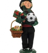 A young boy stocks up on treats and toys for a merry holiday, all while singing beloved holiday carols. An adorable figurine from the Bearing Gifts family, with the handcrafted charm of Byers' Choice.