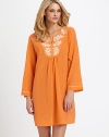 An eternally chic piece of breathable pure cotton with delicate embroidery at the neckline. Split jewel necklineLong sleeves with contrast stitching at the cuffsCenter ruching for added drapeAbout 36 from shoulder to hemCottonMachine washImported