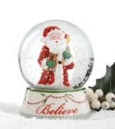 Santa Claus and a sweet teddy bear get in the spirit in this beautifully crafted Believe snow globe, featuring mistletoe and cranberry garland and a flurry of sparkles from Spode.