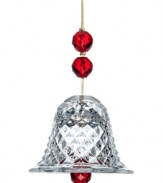 Set the tone for a beautiful holiday. The bell ornament from Baccarat illuminates the tree with faceted red beads and cut crystal on a strand of gold.