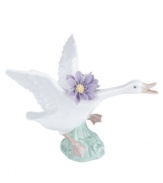 Taking flight with big purple blossoms in tow, this leaping duck captures the grace of nature in lustrous Lladro porcelain.