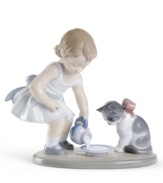 An adorable little girl dotes on her kitten, both the picture of innocence in exquisite, softly shaded Lladro porcelain.