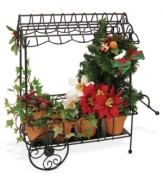 Brimming with the traditional red and green plants of Christmas, this handcrafted cart complements the Cries of London figurines, also from Byers' Choice.