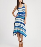 Concluded with a unique handkerchief hem, this stunning scoopneck has an elasticized drop waist and striped print. ScoopneckSleevelessElasticized drop waistAsymmetrical handkerchief hemAbout 38 from natural waist96% rayon/4% spandexHand washMade in USAModel shown is 5'10 (177cm) wearing US size Small.