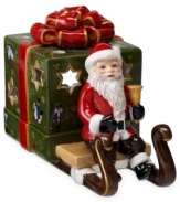 Santa Claus carries a brilliant surprise on the back of his sleigh in this beautifully crafted candle holder from Villeroy & Boch. Light shines through pierced stars in a present wrapped in charming vintage style.