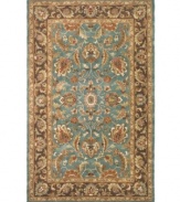 A choice color blue behind a myriad of intricate and vibrant floral medallions creates a simply elegant and rich Persian-inspired rug from Safavieh. Hand-tufted and woven from pure wool by experienced artisans in India, it makes a refined statement wherever placed. (Clearance)