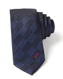 Skinny tie in luxurious silk, with tonal check pattern and embroidered HUGO logo lettering at the end.