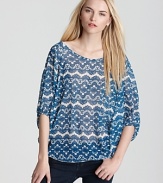 A lace print in a cool blue hue lends pattern play to a dolman sleeve top from Sweet Pea.