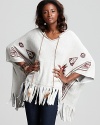 Ingeniously rendered in plush terry, this Vintage Havana hooded poncho spices up your casual wardrobe with a colorful Aztec print, fringed hem and feather detail.