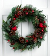 Feather your nest for the holidays. Chirpy red cardinals make their home in a wreath bound with faux holly, pine cones and branches, filling a window or accenting your door with natural charm.