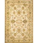 Drawing inspiration from the sandy ruins of ancient Petra and the traditional designs of India, this elegant, hand-tufted rug presents a rich decorative history set against a subtle ivory backdrop and accented with multiple gold and green tones.