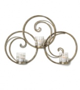 Equal parts wall art and lighting solution, the Symphony Swirl Ring sconce by Mikasa illuminates a room with a festive twist. Featuring whimsical swirls of goldtone metal and glass candle holders wrapped in shimmering ribbons.