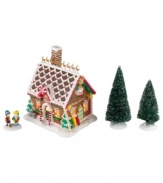 The children of North Pole Village find all the supplies and inspiration they need for new gingerbread houses at Mrs. Claus' Baking Supplies shop. Peppermint spirals, rainbow sprinkles and frosted white accents make it a favorite destination. Two snow-dusted trees complete the scene.