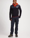 A soft merino wool sweater with a sleek nylon yoke and hood for maximum durability.Hooded style with drawstring bungee cordHalf-zip placket with snap closureNylon yokeLong sleeves with sewn thumb holes at cuffsConcealed side zip pocketsRibbed hemBody: merino wool; hood and yoke: nylonFill: polyesterDry cleanImported