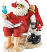 Off-duty Santa! After delivering all those gifts, the big guy deserves to sit back and relax. Sitting on a beach chair with a drink in hand, Santa unwinds and lets his toes run through the sand.