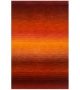 Imparting warm visions of brilliant sunrises on the horizon, this deeply textured rug features intense tones of red and orange that recall a perfect morning sky. Hand-tufted and color blended with the greatest of care, this wool rug comes alive with texture and color.