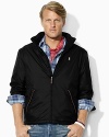 A classic-fitting lightweight windbreaker in high-performance water-resistant microfiber is equipped with a concealed zip-in hood for versatile protection.