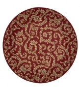 Evoking the opulence of European decor, this round rug features an elegant floral scroll pattern in gold against a rich russet ground, subtly framed in burgundy. The premium wool weave imparts rich texture and indulgent softness.