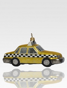 Although the real checker cabs no longer roam the city streets, this sparkling ornament recalls the heyday of these roomy roadsters, crafted of delicate glass with glitter wheels.Handmade and hand-paintedGlassAbout 5L X 2.75H X 2DImported
