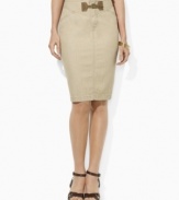 An elegant pencil skirt silhouette is crafted in neutral denim and finished with a heritage faux-suede buckle at the front.