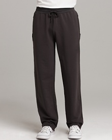 Sweat pants with two front pockets and one back pocket. Unfinished seam detail on sides. Elasticized waist with drawstring closure. Sweat pants with two front pockets and one back pocket. Unfinished seam detail on sides. Elasticized waist with drawstring closure.