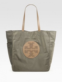 A perforated signature medallion is at the center of this roomy carryall, pairing sleek nylon with luxe Saffiano leather. Double leather top handles, 9 dropMagnetic snap closureTwo outside open pocketsOne inside zip pocketTwo inside open pocketsCanvas lining15W X 14¼H X 5DImported