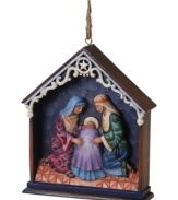 Start at the beginning. The holy family gathers under the Star of Bethlehem in this unique diorama-style nativity scene turned Christmas ornament by Jim Shore.