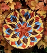 Inspired by the sun-drenched landscape of Rwanda, this meticulously handcrafted bowl rejuvenates decor with vibrant shades and geometric shapes. A thoughtful gift and striking accent piece for your wall or coffee table.