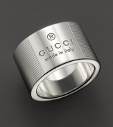 From the Gucci Trademark collection, a sterling silver ring adorned with Gucci logo and etched stripe pattern. Designed by Gucci.