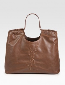 Leather in a cinched top handle carryall, embroidered with the YSL logo.Double top handles, 8½ dropProtective metal feetOne inside open pocketCotton lining17W X 10½H X 5DMade in Italy