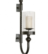 The gracefully twisted metal arm of the Garvin wall sconce plays up its lean profile, which is enhanced by the black metal finish accented with red rust highlights. The finished look is impeccable and poised, just right for traditional settings where every detail counts.