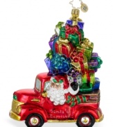 Honk, honk! Santa's Express, with St. Nick in the driver's seat, goes direct to your house with a mound of presents atop a ruby red truck in this Presents for Pickup ornament. Hand-painted from Christopher Radko.
