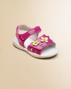 A shiny design for your little princess topped with pretty flowers and double grip-tape closure for easy on and off.Double grip-tape ankle strapsFaux-patent leather upperLeather liningRubber solePadded insoleImported
