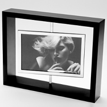 Silver-plate and wood, this stunning rotating picture frame allows you to show 2 photos at a time. Silver-plate and wood, this stunning rotating picture frame allows you to show 2 photos at a time.