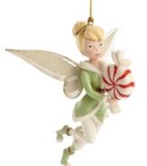 Tinker Bell delivers a sweet treat to your tree – a pixie-sized peppermint! – in this enchanting Disney ornament, featuring gold-dusted porcelain by Lenox.
