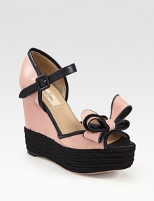 Elegant two-tone leather with an adjustable ankle strap, espadrille wedge and oversized bow adornment. Stacked rope wedge, 5 (125mm)Covered platform, 1 (25mm)Compares to a 4 heel (100mm)Leather upperLeather lining and solePadded insoleMade in ItalyOUR FIT MODEL RECOMMENDS ordering one half size up as this style runs small. 