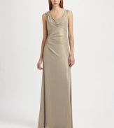 Fluid metallic jersey, in an artfully draped, floor-length style accented with a beaded shoulder detail.ScoopneckShoulder drape with beaded detailSleevelessEmpire seamSide gathers at waistBack cutout with gathered drapeAbout 42 from natural waist95% polyester/5% spandexDry cleanMade in USA of imported fabricModel shown is 5'10 (177cm) wearing US size 4. 