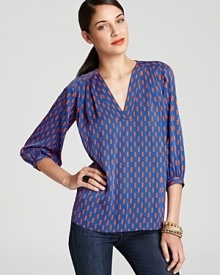 Blazing orange and brilliant blue provide a smart counterpoint to the '70s-inspired silhouette of this DIANE von FURSTENBERG blouse. Blazing orange and brilliant blue provide a smart counterpoint to the '70s-inspired silhouette of this DIANE von FURSTENBERG blouse.